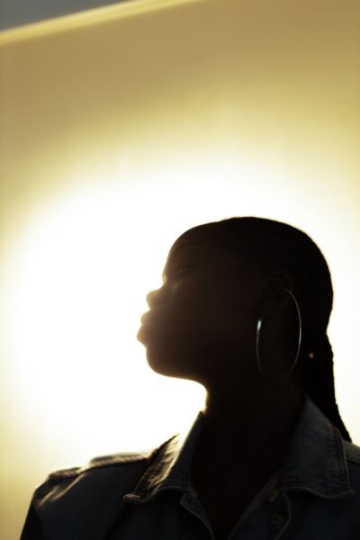 a silhouette of a woman with ear rings
