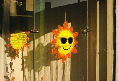 Two sun decorations hang on a wooden door.